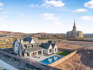 View of swimming pool with patio surround, a fenced backyard, and a mountain view