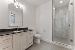 Full bathroom with a marble finish shower, vanity, recessed lighting, and light tile patterned floors