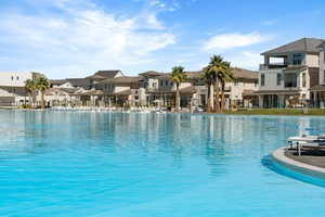 Community pool with a residential view and a patio area