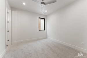 Carpeted empty room with recessed lighting and a ceiling fan