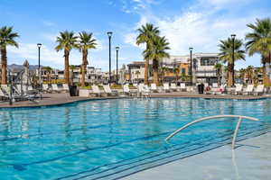 Community pool with a residential view and a patio area
