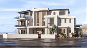View of front of house with stone siding, a gate, a fenced front yard, stucco siding, and a balcony