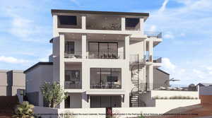 Back of house featuring a balcony and stucco siding