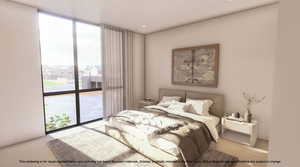 Bedroom with expansive windows, carpet floors, and access to outside