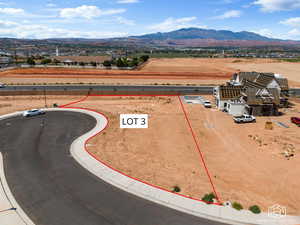 Aerial view of property's location featuring mountains and property parcel outlined