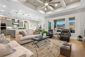 Living area with light wood finished floors, recessed lighting, a ceiling fan, and coffered ceiling