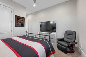 Bedroom with light carpet, a ceiling fan, and recessed lighting