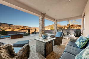 Fenced backyard with a mountain view, a patio, a grill, and outdoor lounge area