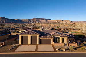 View of front facade featuring a garage, concrete driveway, and a mountain view