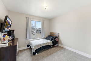 Bedroom featuring carpet floors and a textured ceiling