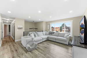 Living area featuring light wood-style flooring and recessed lighting