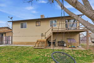 Rear view of property with a gate, a chimney, and a patio