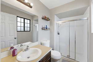 Bathroom featuring a stall shower and vanity