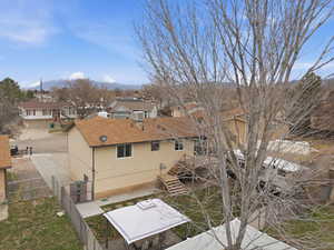Rear view of property featuring a residential view, a fenced backyard, and a patio area