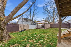 Fenced backyard with a gazebo and a patio