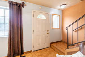 Entrance foyer featuring light wood finished floors and stairway