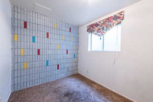 Carpeted spare room with baseboards