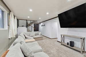 Living area with carpet floors, recessed lighting, and ornamental molding