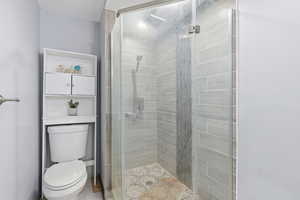 Full bath with a stall shower and toilet