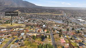 Aerial view of property's location with nearby suburban area and a mountain backdrop