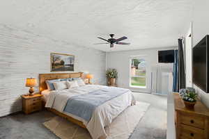 Carpeted bedroom featuring wooden walls and ceiling fan
