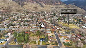 Aerial view of property's location with nearby suburban area and a mountainous background