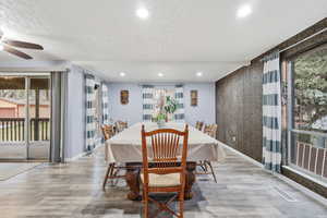 Dining room with healthy amount of natural light, wood finished floors, recessed lighting, and ceiling fan