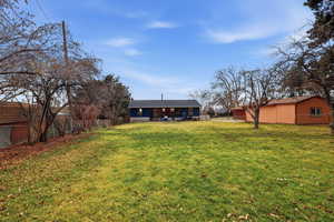 Rear view of property with a shingled roof