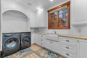Laundry area featuring washer and clothes dryer, cabinet space, light floors, and recessed lighting