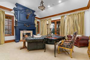 Carpeted living room featuring lofted ceiling, a large fireplace, and recessed lighting