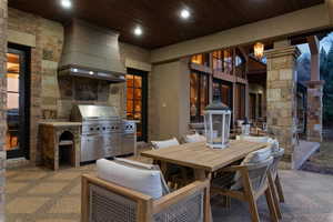 View of patio featuring an outdoor kitchen / dining area and an outdoor fireplace