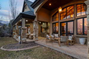 Patio terrace at dusk featuring area for grilling, a patio area, and a yard