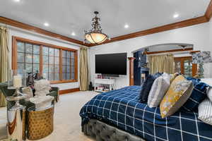 Bedroom with crown molding, carpet floors, arched walkways, and recessed lighting