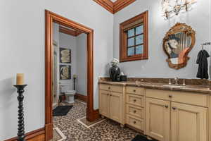 Bathroom featuring ornamental molding and vanity