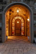 Property entrance featuring stone siding and brick siding