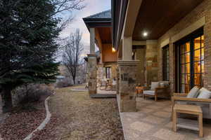 Yard at dusk with outdoor seating and a patio