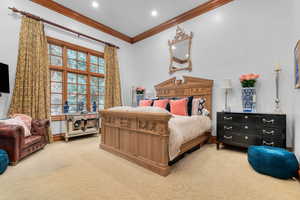 Bedroom featuring light carpet, ornamental molding, and recessed lighting