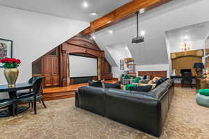 Home theater featuring beamed ceiling and recessed lighting