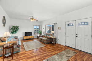 Living room featuring wood finished floors and ceiling fan