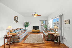 Living room featuring wood finished floors and a ceiling fan