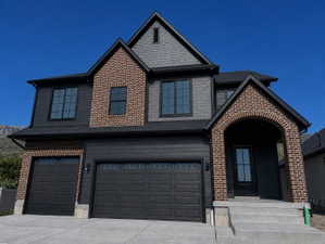 2-story home with brick and fiber cement. 3-car garage.  Beautiful arched front porch entrance.
