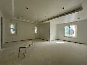 Primary bedroom featuring a raised ceiling