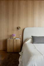 Sconces and Wood Paneling in the Primary Bedroom