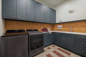 Laundry Room with Plenty of Cabinet Space, Washer &Dryer, and a Skylight
