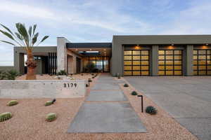 Three 10'x10' Garage Doors, Volcanic Stone, and Metal Accents on the Exterior