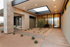 Open Ceiling for Tree Growth, Volcanic Stone that Flows all the Way Through the Home, and Floor to Ceiling Windows