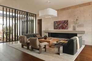 Living Area with Huge Floor to Ceiling Windows, Volcanic Stone Flowing From the Front all the Way Through to the Backyard