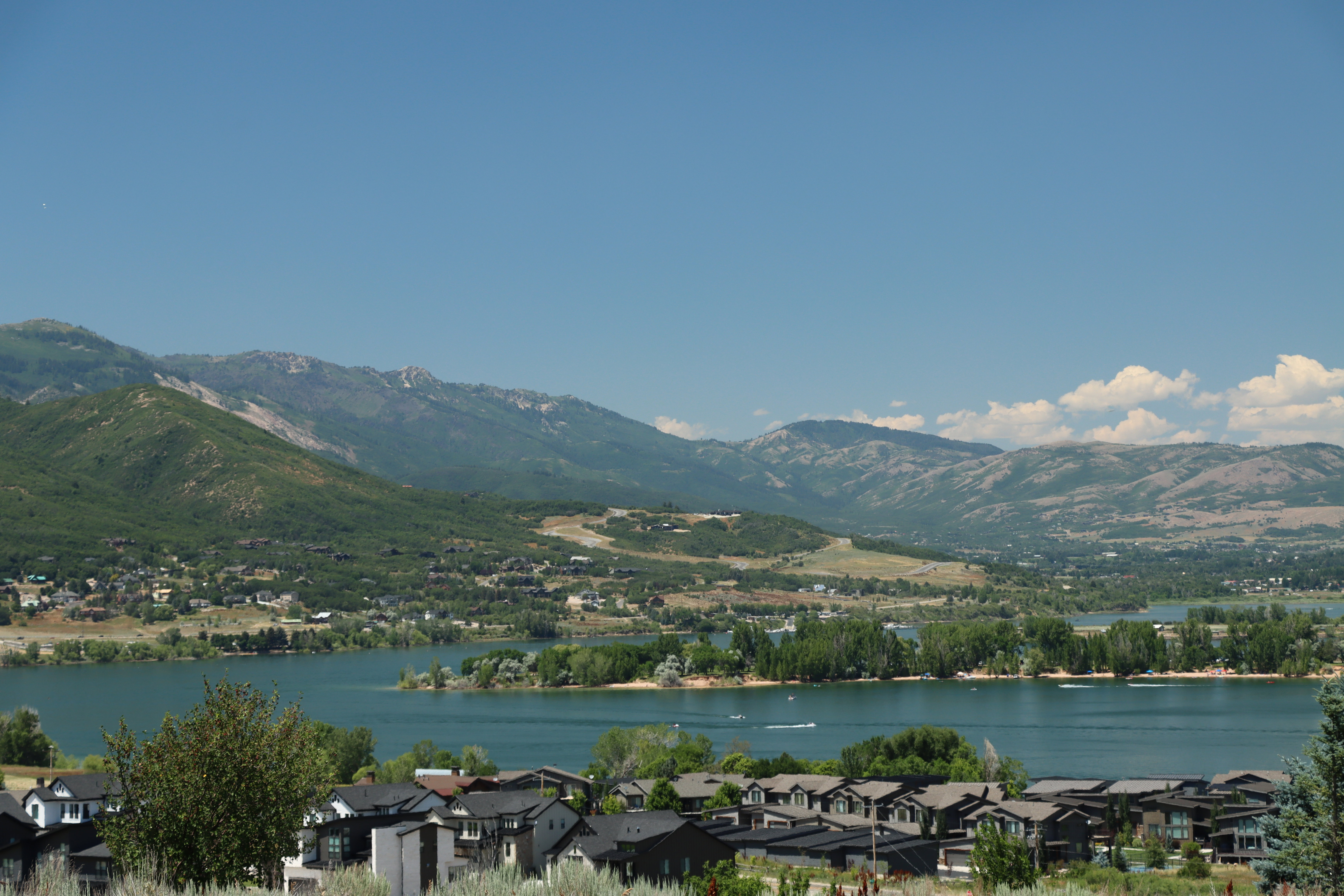 Water view featuring mountains and nearby suburban area