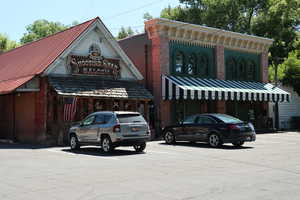 View of commercial property with uncovered parking