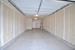 Garage featuring strapped water heater